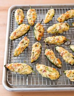 baked stuffed jalapenos on a cooling rack ready to be cooked in the oven