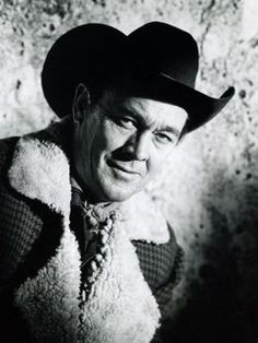 black and white photograph of a man wearing a cowboy hat