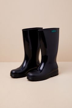 Splish splashing through puddles has never been cuter thanks to the Melissa Welly Black Rubber Knee-High Rain Boots! These classic rain boots have a shiny rubber construction (with an intentional-yet-subtle bubble-gum scent) that shapes a rounded-toe upper and an 11"" knee-high shaft with a 15.5"" circumference. The simple slip-on design makes these an effortless addition to any storm-ready 'fit, all atop a textured lug sole. Available in whole sizes only. 1. 5" rubber heel. Lightly cushioned insole. Rubber sole has nonskid markings. Man Made Materials. Imported. Lulus | Welly Black Rubber Knee-High Rain High Heel Boots | Size 9. Cold Weather Shoes, Cute Rain Boots, Black Rain Boots, Sketchbook Ideas, Slip On Boots, Rubber Boots, Heel Boots, Rubber Heels, Lug Sole