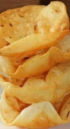 some chips are stacked on top of each other and ready to be eaten by someone