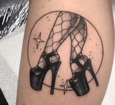 a woman's thigh with high heeled shoes on it and stars in the background