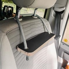 the back seat of a car with a cup holder attached to it's side