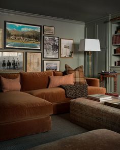 a living room filled with furniture and pictures on the wall