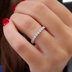 a woman's hand with a diamond ring on it