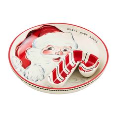 a santa clause plate with red and white striped socks on it's side, sitting in front of a white background