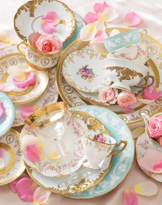 a table topped with lots of plates covered in flowers