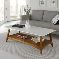 a living room with a couch, coffee table and pictures on the wall