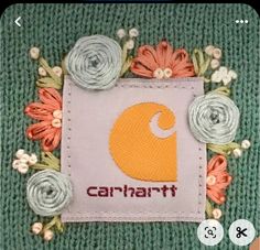 an applique with flowers and the word carnart on it