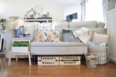 a living room filled with furniture and flowers on the table in front of the couch