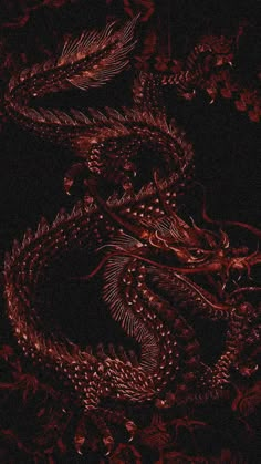 a red dragon is sitting in the dark