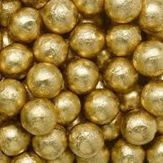 gold foiled chocolate balls are stacked on top of each other