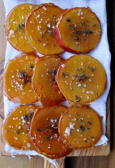 sliced up peaches on a cutting board with herbs and salt sprinkled on top