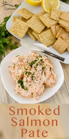 smoked salmon pate on a plate with crackers and lemons in the background