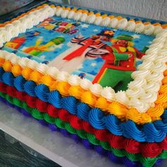 there is a large cake decorated with colorful icing