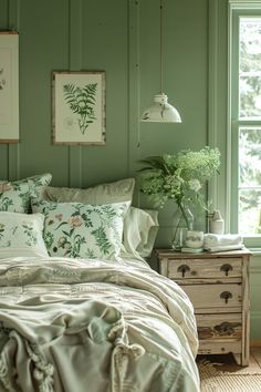 a bedroom with green walls and white bedding