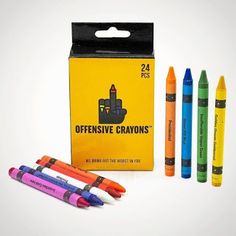 three different colored crayons sitting next to each other in front of a box