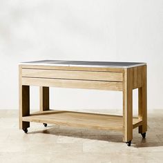 a wooden table sitting on top of a tiled floor