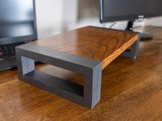 a wooden table with two computers on it