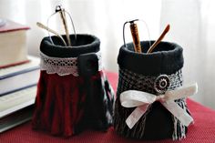 two pairs of black and white knitted boots with bows on them, sitting next to each other