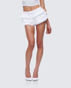 Nothing screams demure quite like a white bloomer skort 😌 With flirty ruffles and a cheeky cut, this piece made from a blend of cotton and lace fabric has built in shorts, making it the best of both worlds when it comes to effortless style 🤍 White Ruffled Mini Bottoms, Flirty Mini Shorts With Ruffles, Summer Voluminous Ruffled Mini Skirt, White Ruffle Hem Mini Skort, White Ruffled Short Mini Skirt, Ruffle Bloomers, Black Off Shoulder, Graphic Top, White Jersey