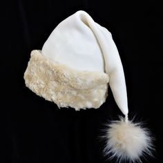 Santa hat is made up in a cozy poly fleece ivory tone fabric and trimmed with a quality soft as can be beige faux fur turn up brim.  Hat is styled in the traditional Santa slouch style stocking hat and is generously sized to fit most teen and adult head sizes. Measurement of the hat band is 24"- 25" circumference, and the length of the hat is 20". There is a fluffy faux fur pompom dangle stitched on the tip. Check measurements to make sure this size will work for you. Christmas Party Hats, Santa Costume, Stocking Hat, Faux Fur Pom Pom, Costume Hats, Fur Pom Pom, Hat Band, Fur Trim, Santa Hat