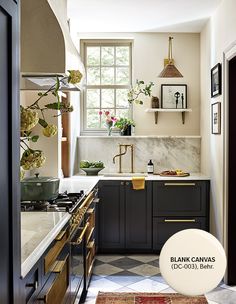 a kitchen with marble counter tops and black cabinets, along with an open window to the outside