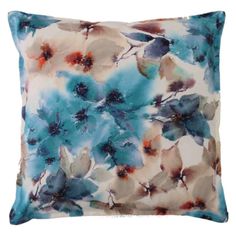 a blue and white floral pillow on a white background with red, orange, and blue flowers