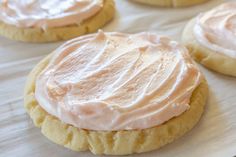 some cookies with frosting on them sitting on a table