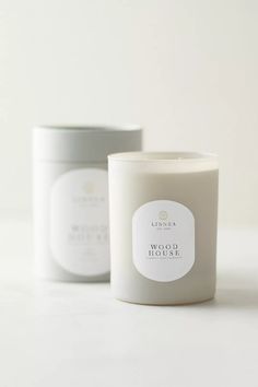 two candles sitting next to each other on a white counter top, one candle has a label that says sea salt