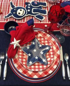 a red, white and blue table setting with silverware