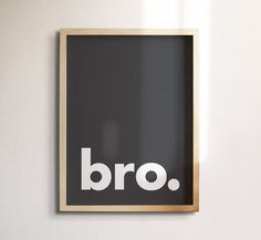 a black and white photo with the word bro written on it, hanging on a wall