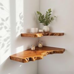 two wooden shelves with candles and vases on them in the corner of a room