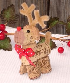 a wooden dog figurine with a bow on it's head and some leaves