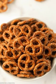 a white bowl filled with pretzels on top of a table