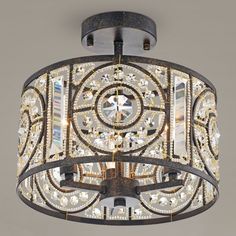 a chandelier hanging from the ceiling in an ornate style with crystal stones and metal accents