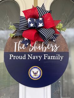 a sign that says the sailors proud navy family with an american flag bow on it