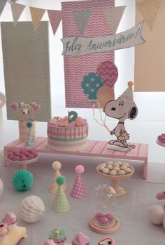 a table topped with lots of cakes and cupcakes