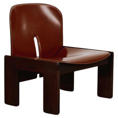 a brown leather chair sitting on top of a wooden table