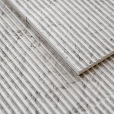 a close up view of a tile floor with white lines on the top and bottom