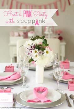 the table is set with pink and white flowers