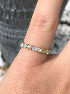 "Unique Opal and Diamond Band Ring. Vintage Sophisticated Opal band with Diamonds. Material: Solid Gold (14K & 18K) Finishing: High Polished, Shiny Fit: Standard Width: 2.2 mm, Top 3.4mm w/ Xs, 2.7mm w/o Xs Height: 1.4 mm, top - 1.9mm Setting: Bezel Stone: Natural Opals Shape: Marquise Size: 2mm x 4mm Quantity: 3 Opals Stone: Authentic Diamonds Conflict Free Clarity: VS Color: G-H Cut: Brilliant Quantity: 4 x 1.3mm Diamonds This matching band will turn your Engagement Solitaire into a Weddin Band With Diamonds, Infinity Diamond Ring, X Ring, Unique Opal, Opal Band, Sparkly Ring, Diamond Band Ring, Unique Bands, Opal Ring Gold