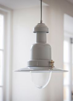 a white light hanging from a ceiling in a room