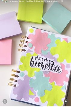 an open planner book with pastel colors and writing on it