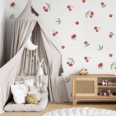 a child's bedroom with cherries on the wall and a canopy bed in front of it