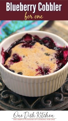 blueberry cobbler in a white dish with text overlay that reads, how to make blueberry cobbler for one