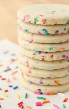 a stack of white cookies with sprinkles on them