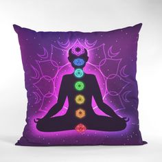 a pillow with the image of a person sitting in yoga position surrounded by seven chakras