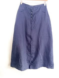 "Vintage navy blue linen blend skirt with faux pockets. Skirt is in an A Line style and features a button front. The skirt is not lined but is a very soft linen blend and perfect for breezy summer wearing. CONDITION: Like-New vintage condition with no tears, rips, stains or any sign of other visible defects. MEASUREMENTS: All measurements are taken while the garment is laying flat.  Waist: 14.5\"  Hips: 20\"  Length:  35\"  Size: 44  Material: Linen blend" Summer Linen Button-up Bottoms, Button-up Linen Bottoms For Day Out, Linen Button-up Bottoms For Day Out, Relaxed Linen Workwear Skirt, Relaxed Linen Skirt For Workwear, Summer Linen Skirt For Workwear, Linen Flared Skirt For Workwear, Summer Linen Maxi Skirt For Work, Flared Linen Skirt For Work