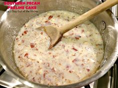 a wooden spoon in a pan filled with food