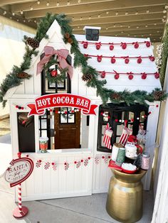 a toy house with candy bar and christmas decorations on the front door for kids to play in